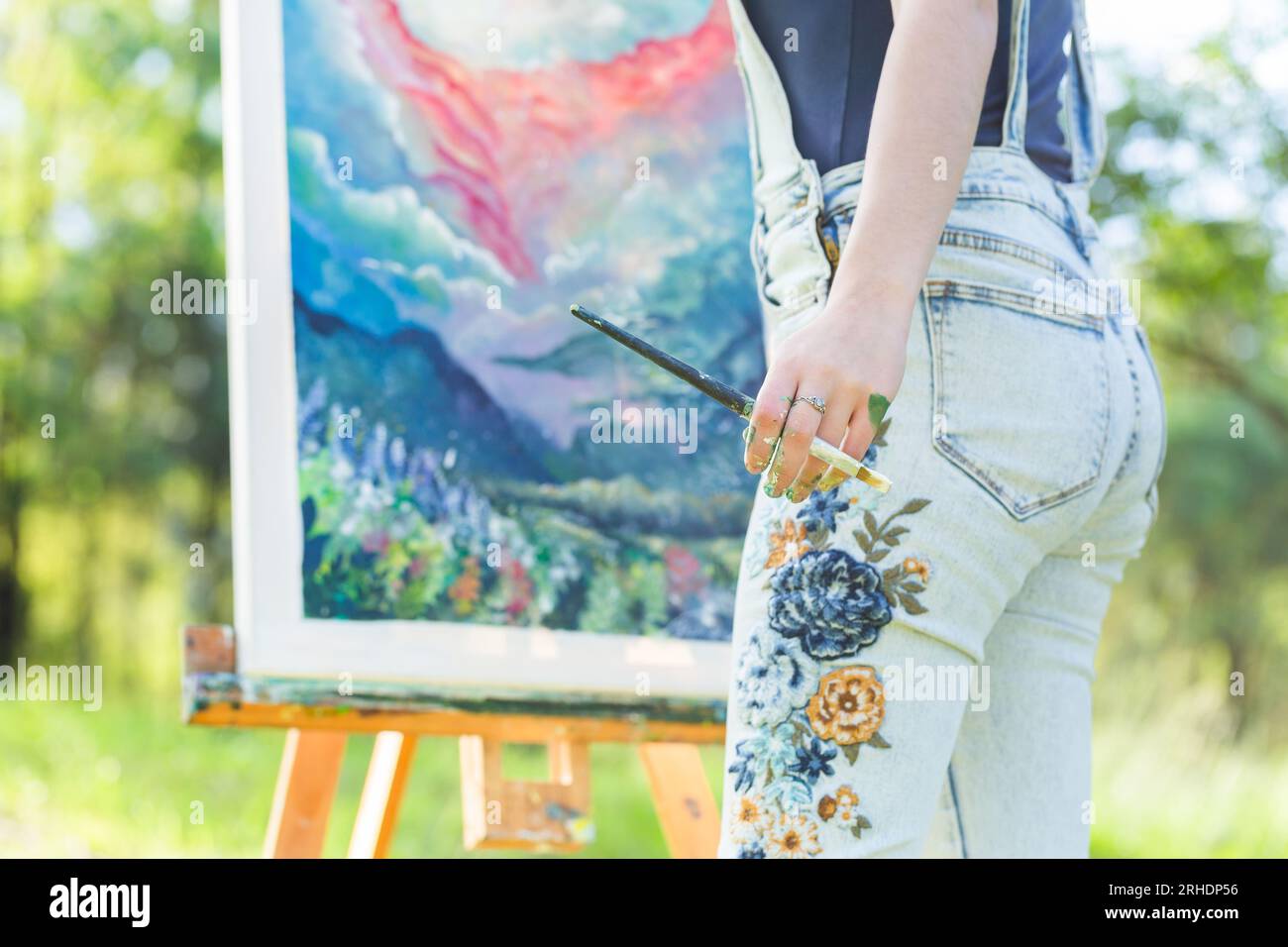 Young Australian artist painting magical scenery in forest Stock Photo