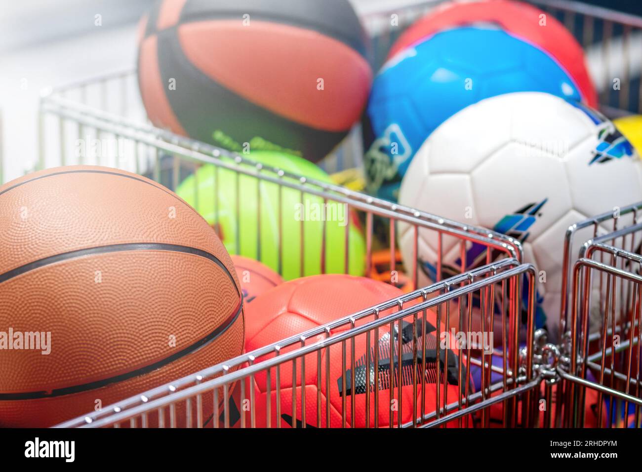 Chooses volleyball and soccer ball in the sports shop. Group of balls the team games Stock Photo