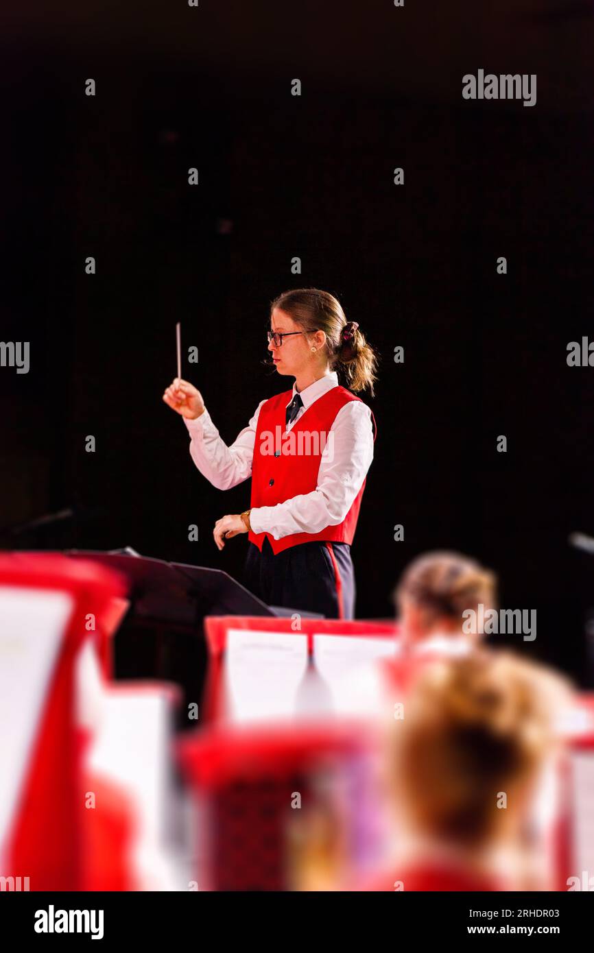 young band conductor conducting live performance Stock Photo