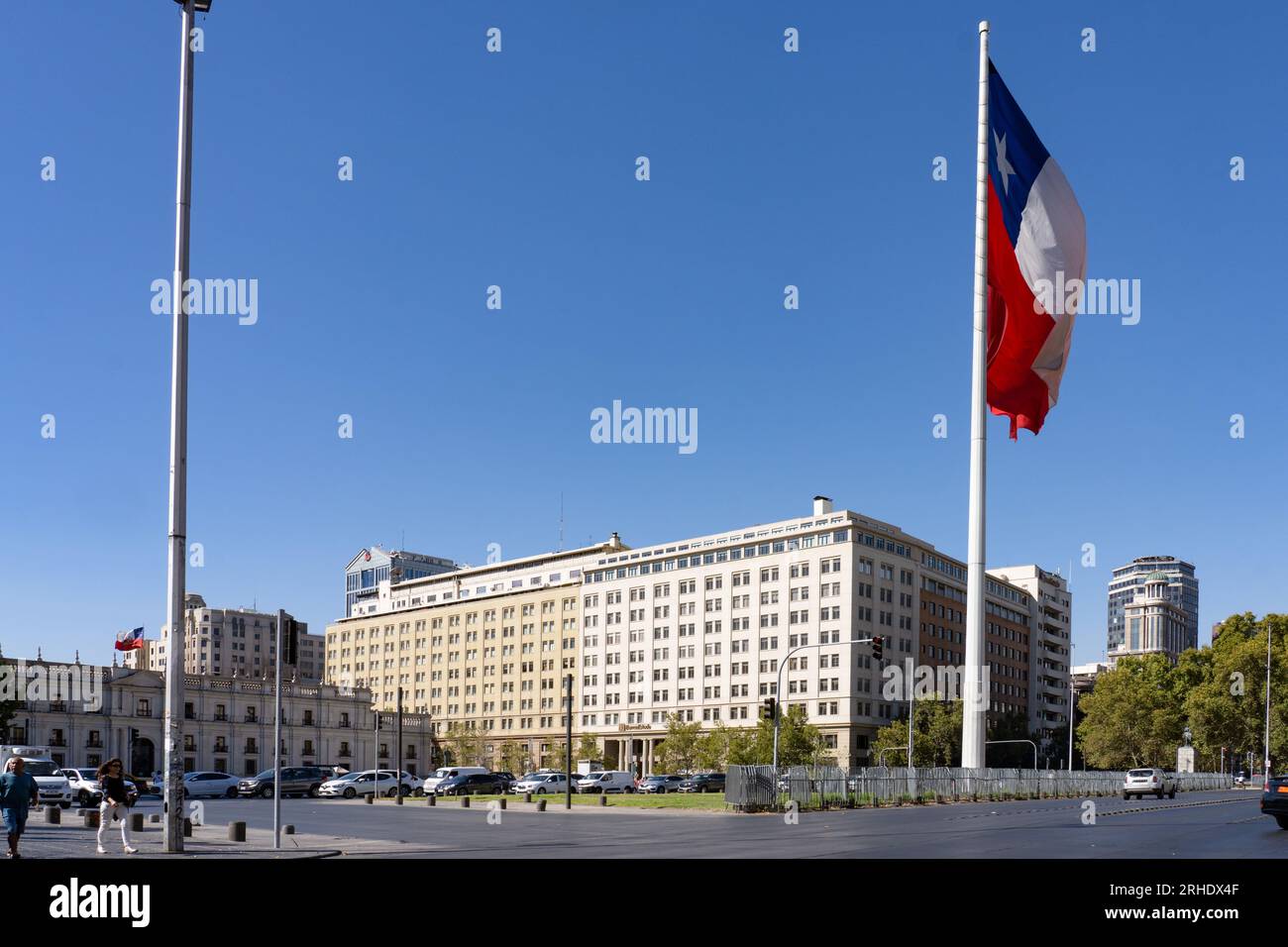 Huge Chilean flag in front of the La Moneda Palace, left, and the Banco Estado building in downtown Santiago, Chile. Stock Photo