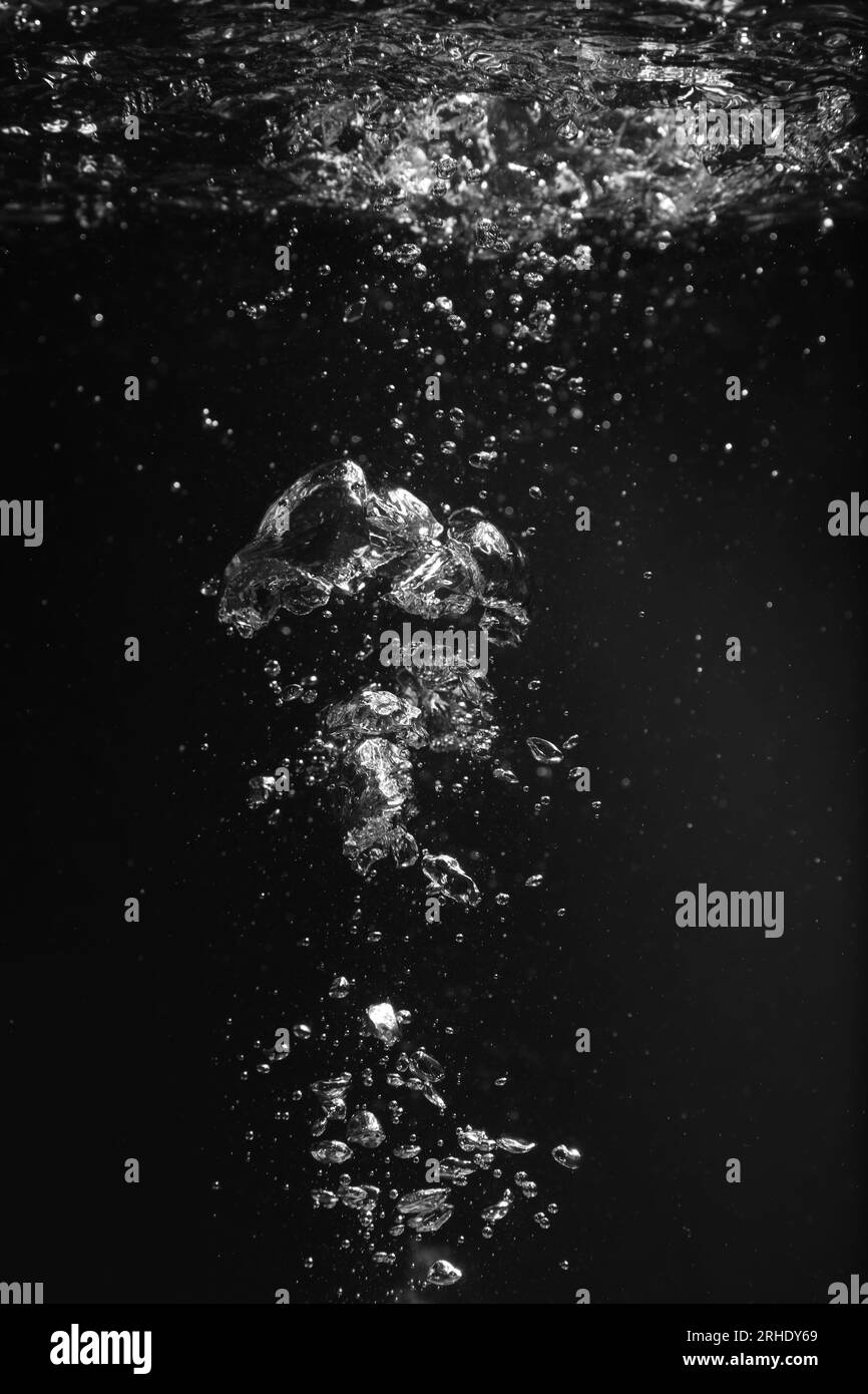 Air bubbles in water on black background Stock Photo