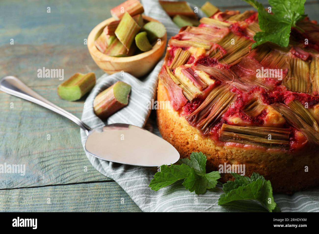 Freshly baked rhubarb pie, green leaves and cake server on wooden table,  closeup. Space for text Stock Photo - Alamy