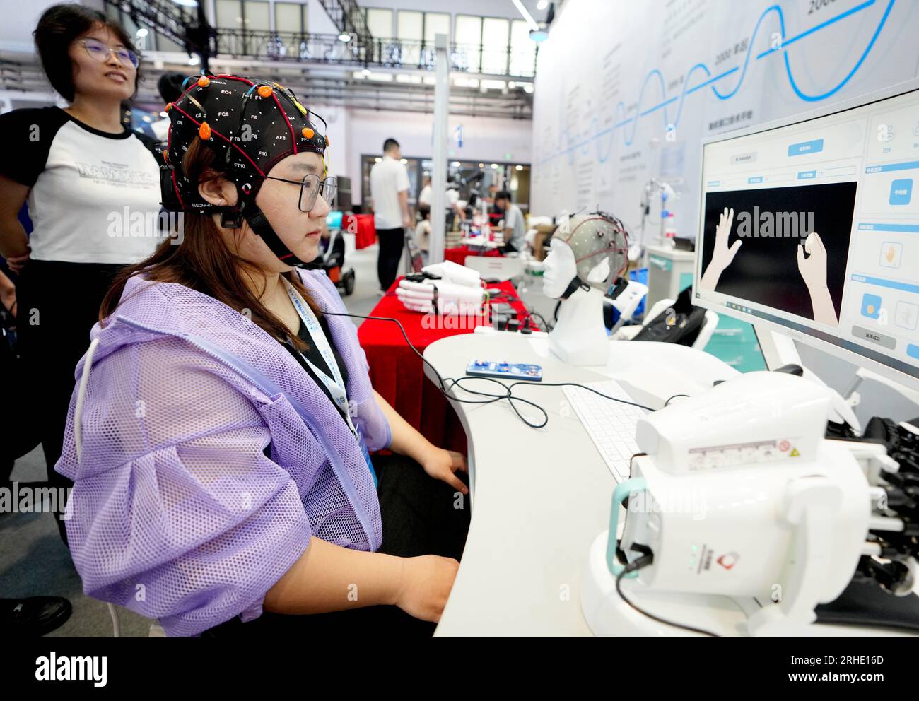 Beijing, China. 16th Aug, 2023. A staff member demonstrates a brain ...