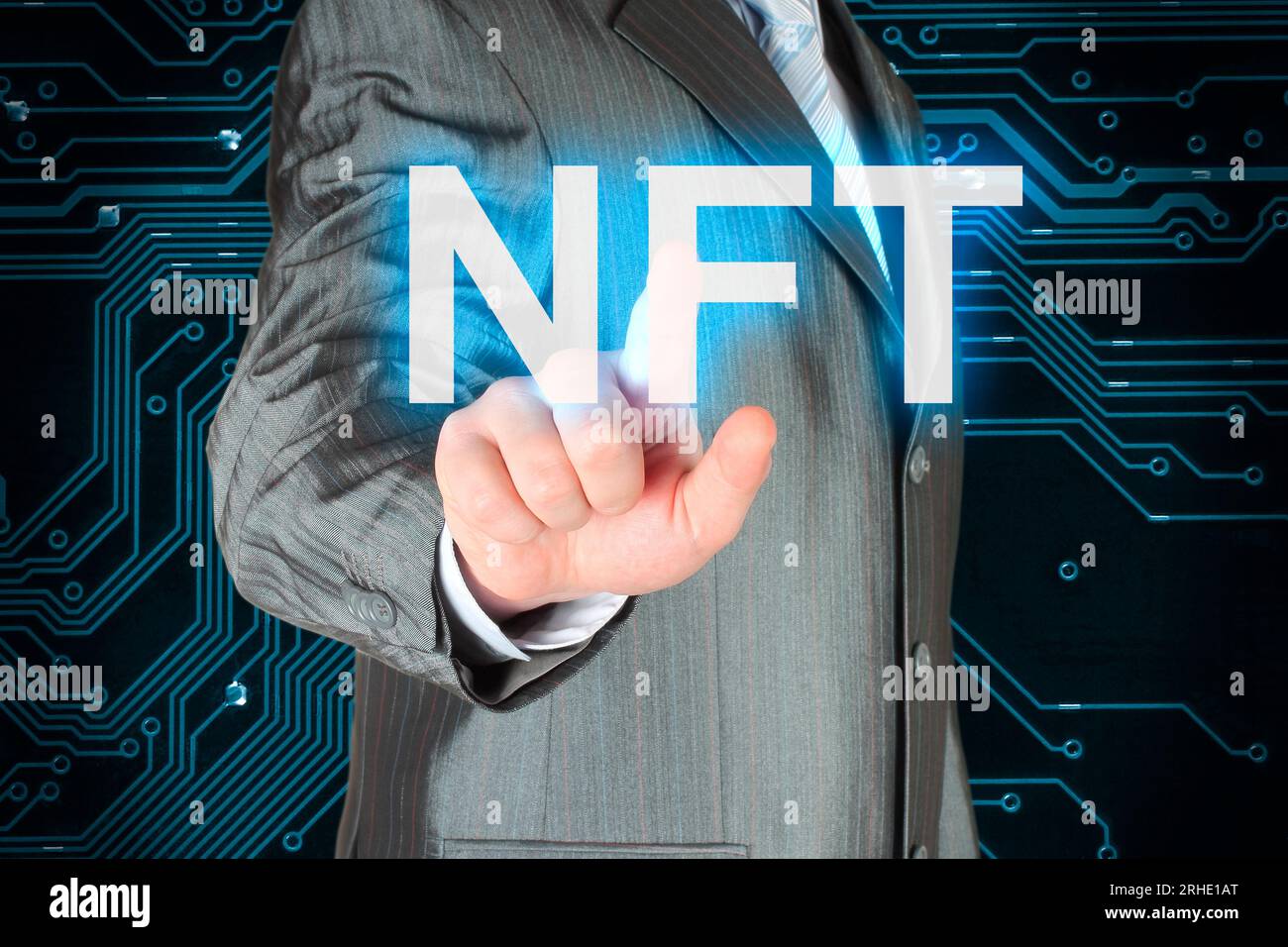 Businessman pushing virtual NFT button, on digital background close-up Stock Photo