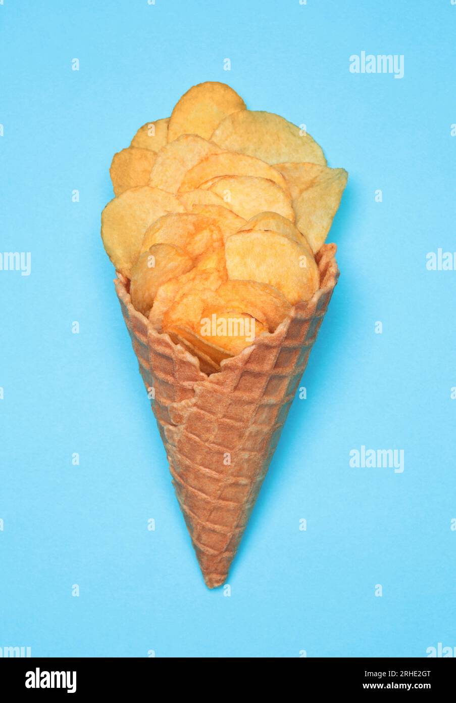 Waffle Cone with Potato Chips on blue background. Fast Food concept