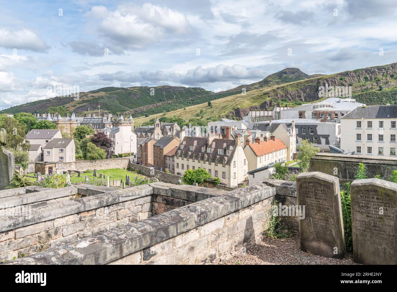 Graves in New Carlton burial ground with a part of the old town, Holyroodhouse and the new Scottish Parliament behind, Edinburgh, Scotland Stock Photo