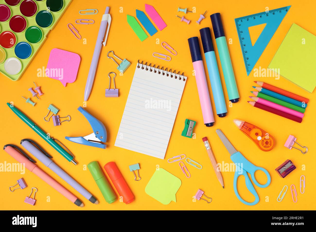School and office supplies on yellow background, mock-up top view close-up Stock Photo