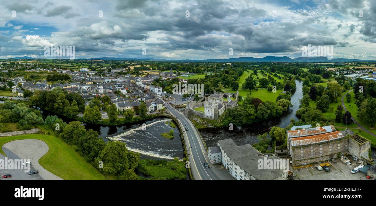 Aerial view of Cahir castle and town in Ireland with Tower House, outer castle, circular, rectangular towers, banquette hall, guarding the crossing Stock Photo