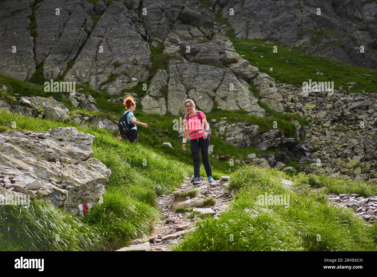 Two hikers climb steep rocky hi-res stock photography and images - Alamy
