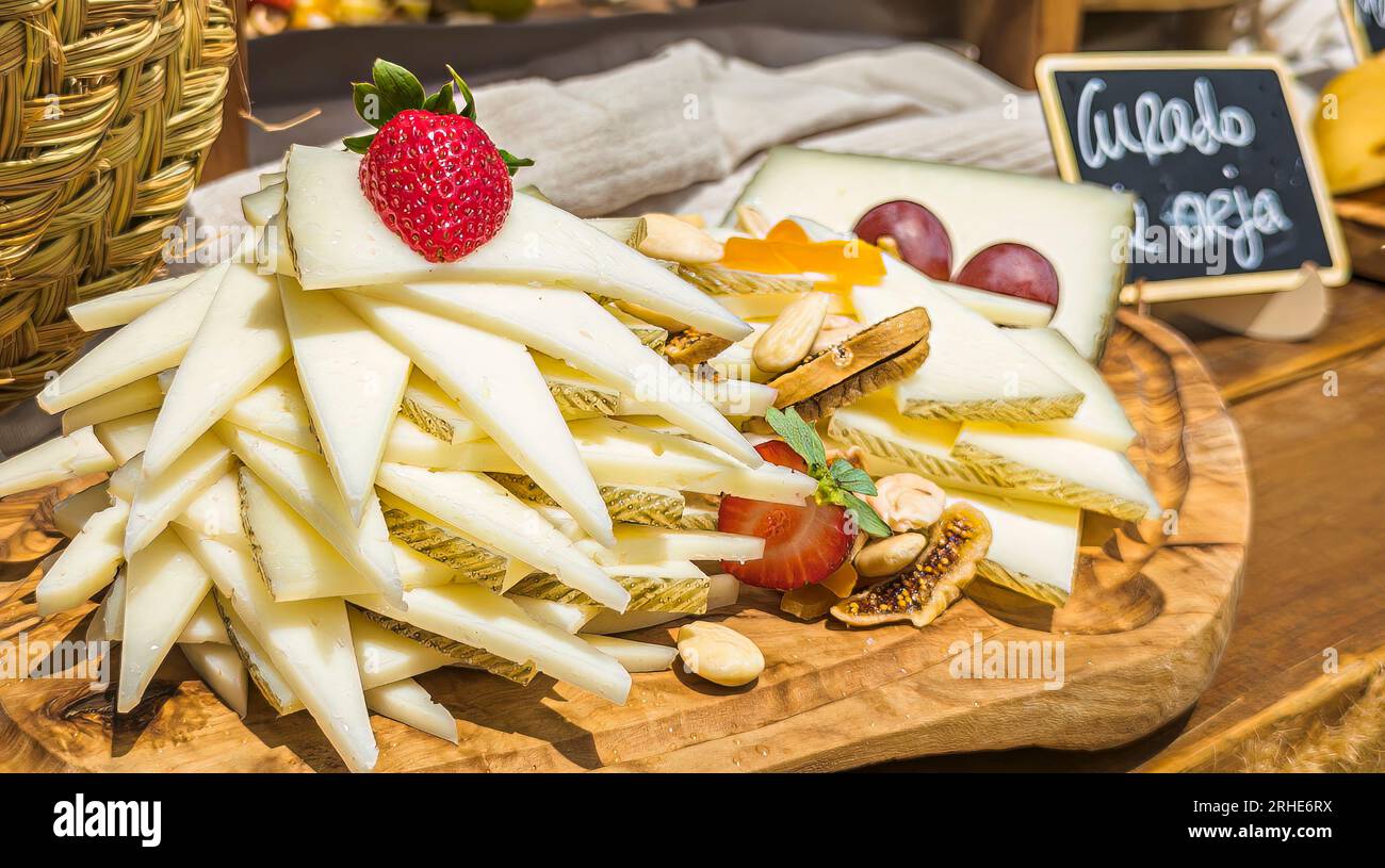 free cheese buffet on wooden boards and with decorations for an event and professionally presented Stock Photo