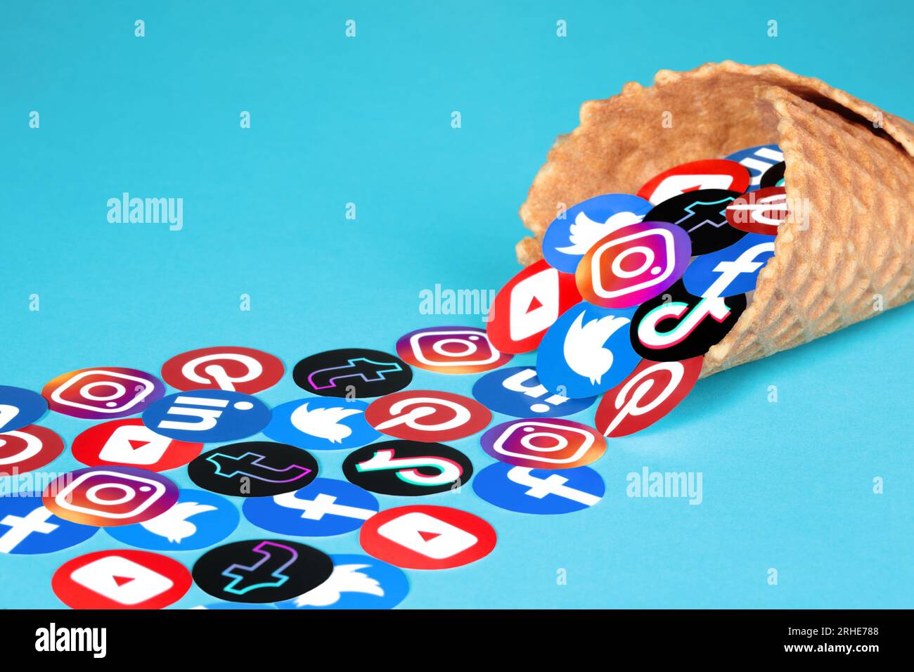 Kiev, Ukraine - August 15, 2022: Popular Social Media apps icons scattered from Waffle Cone, on blue background Stock Photo