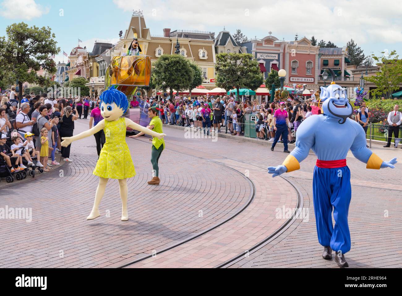 Disneyland Paris - the Disney Parade with disney characters Peter Pan, Joy and The Genie dancing in front of visitors; Disneyland Paris, France Stock Photo