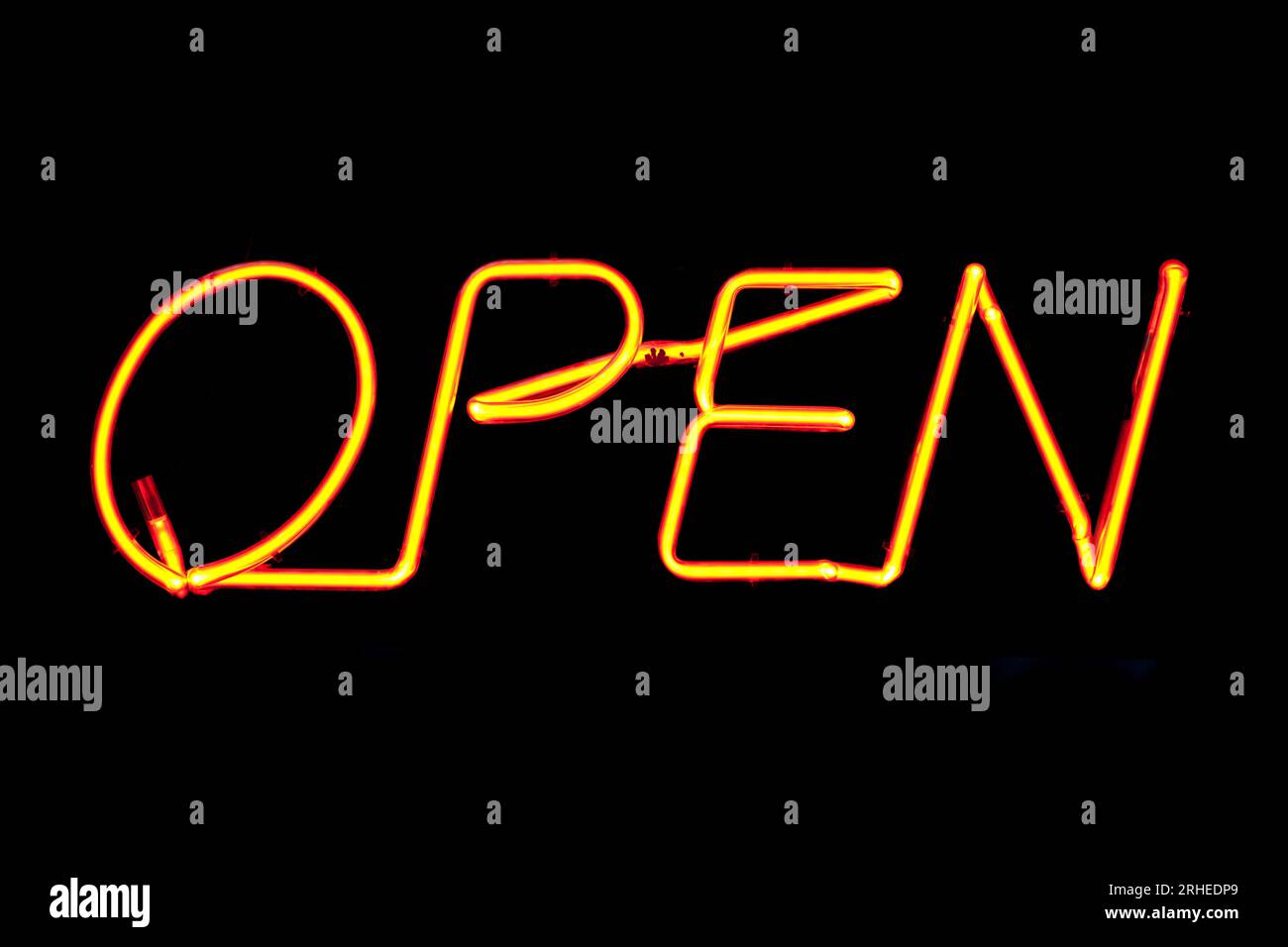 An orange neon sign inside the window of an Irish Pub saying 