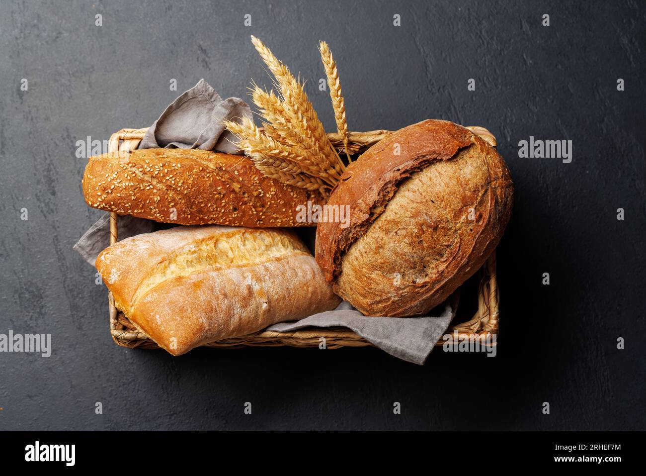 Assorted bread varieties in a charming basket, ready to be enjoyed