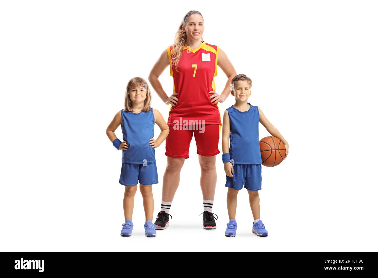 Children and a female basketball coach posing isolated on white