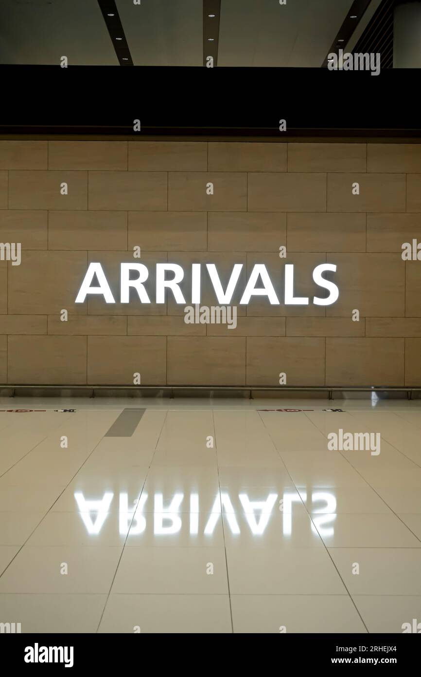 Arrivals sing on the wall in the airport Stock Photo