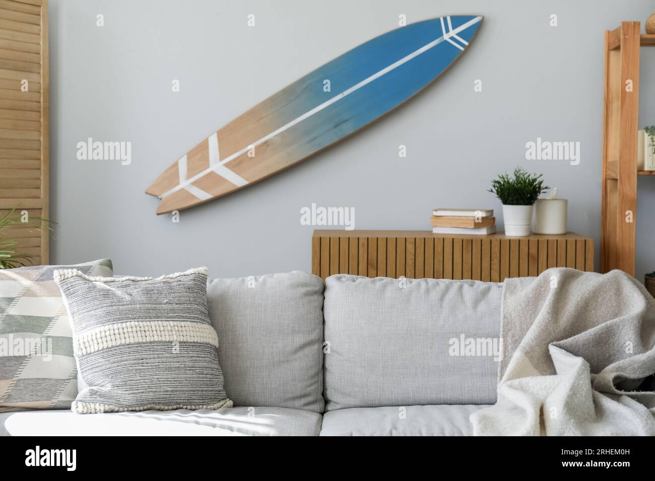 Surfboard hanging on light wall in living room Stock Photo Alamy