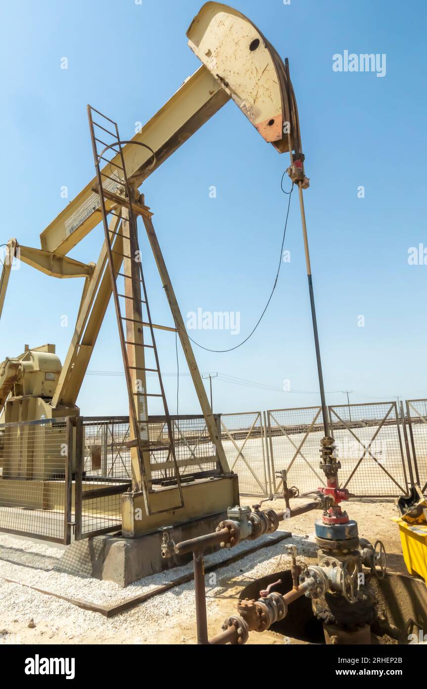 Pump jack,oil horse, oil jack, beam pump extracting crude oil from oil well in the Bahrain desert Stock Photo