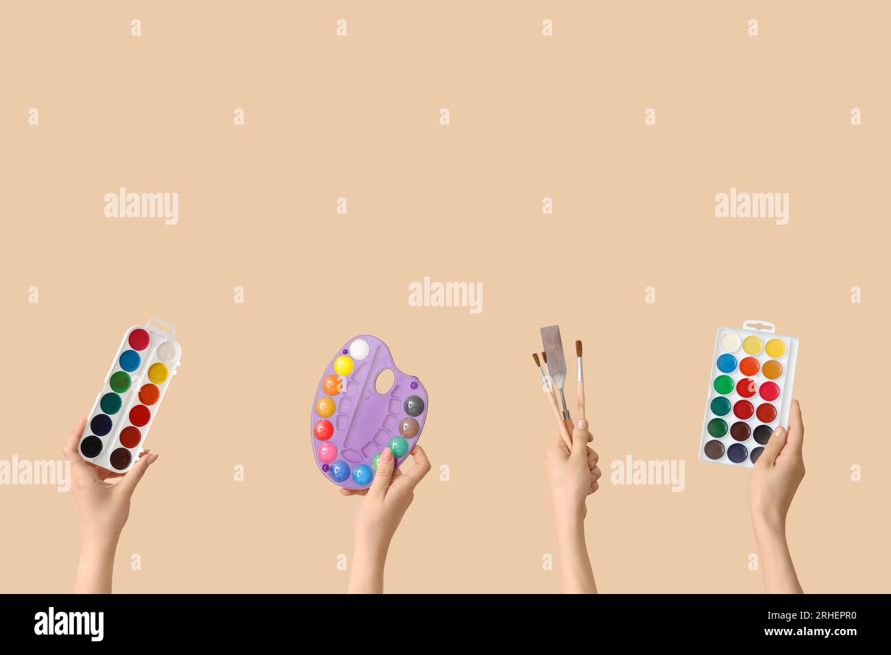 Female hands with artist's supplies on beige background Stock Photo - Alamy