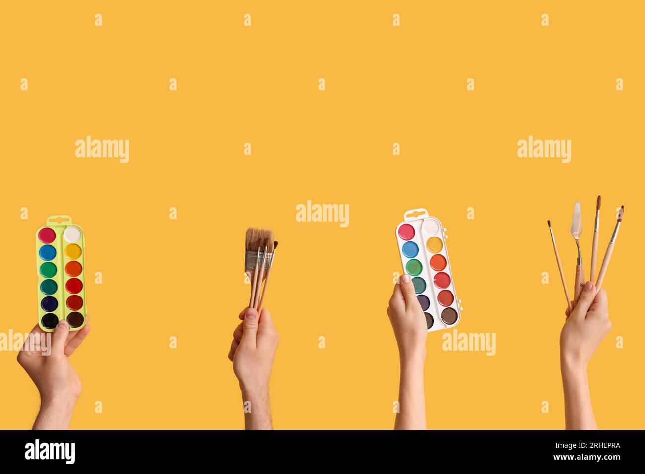 Female hands with artist's supplies on yellow background Stock Photo ...