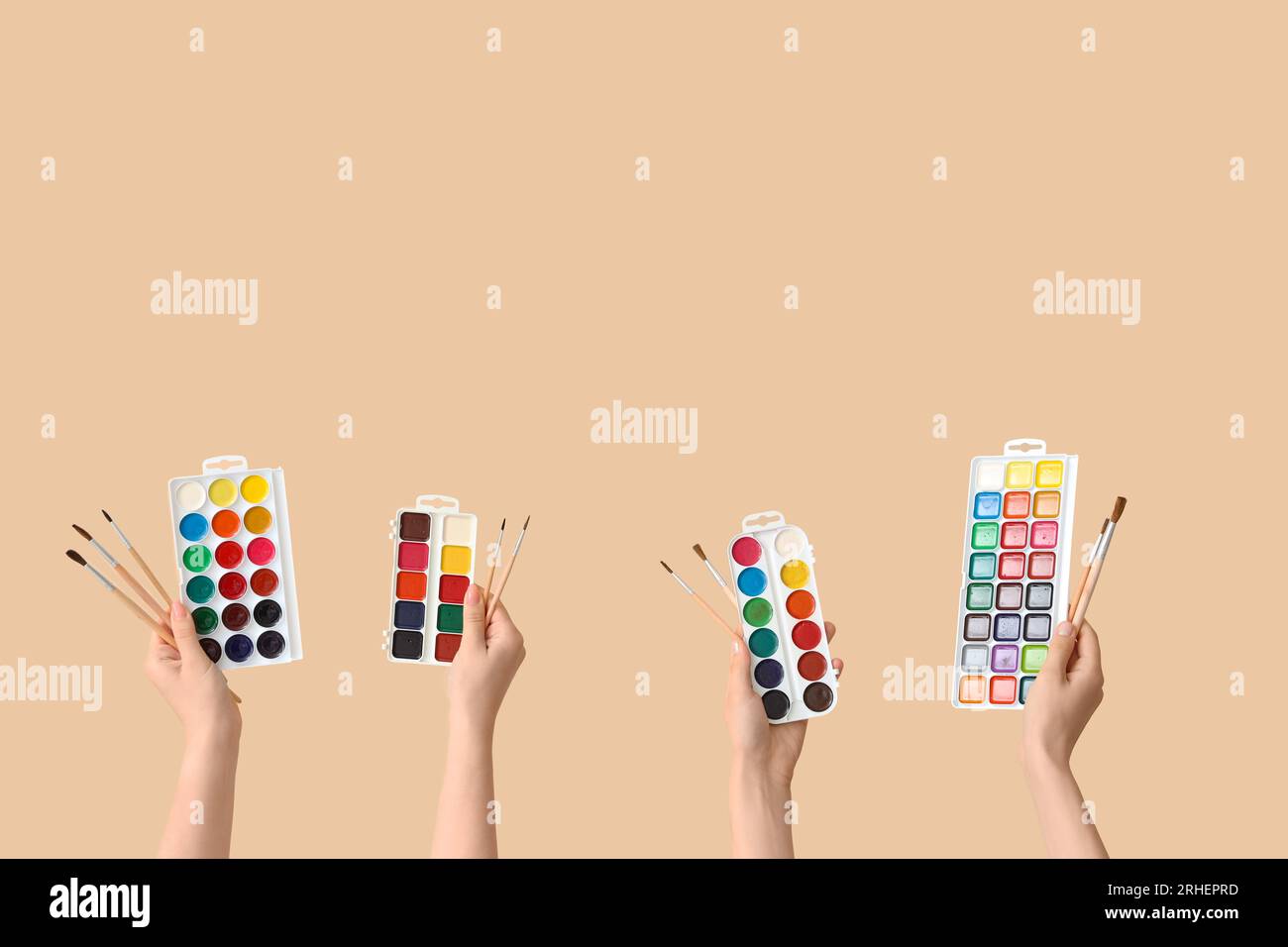 Female hands with artist's supplies on beige background Stock Photo - Alamy