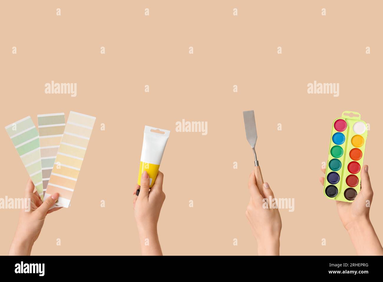 Female hands with artist's supplies on beige background Stock Photo - Alamy