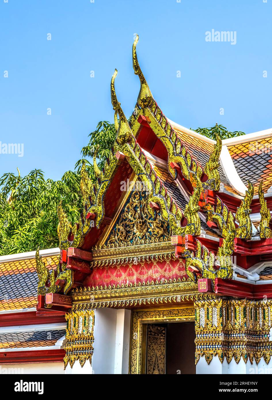 Golden Red Buddha Relief Pavilion Roof Wat Pho Po Temple Complex Bangkok Thailand. Built in 1600s. One of oldest temples in Thailand. Stock Photo