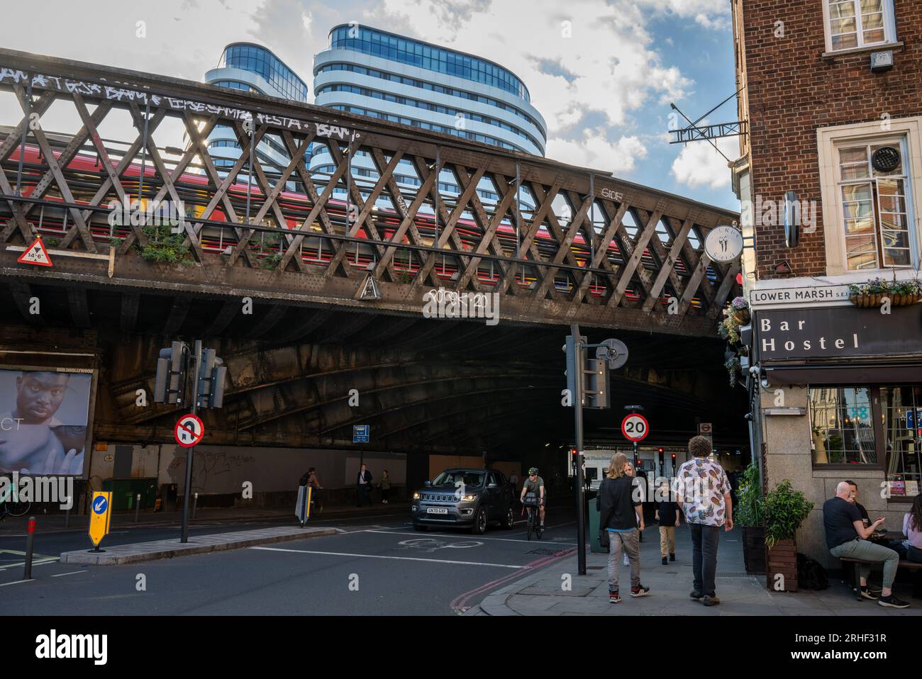 London, UK: The junction of Lower Marsh and Westminster Bridge Road close to Waterloo Station in London. A train passes over a railway bridge. Stock Photo