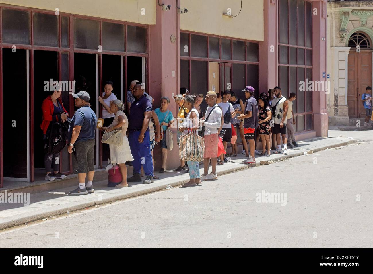 Havana, Cuba, Cuban people liningup or waiting in line. The building can be a store or a bank