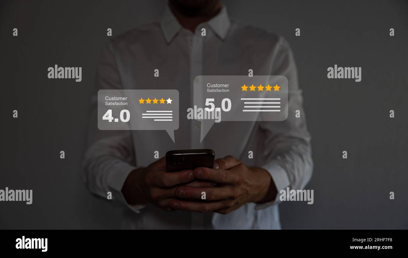 Close up on customer man hand pressing on smartphone screen with gold five star rating feedback icon and press level excellent rank. Stock Photo