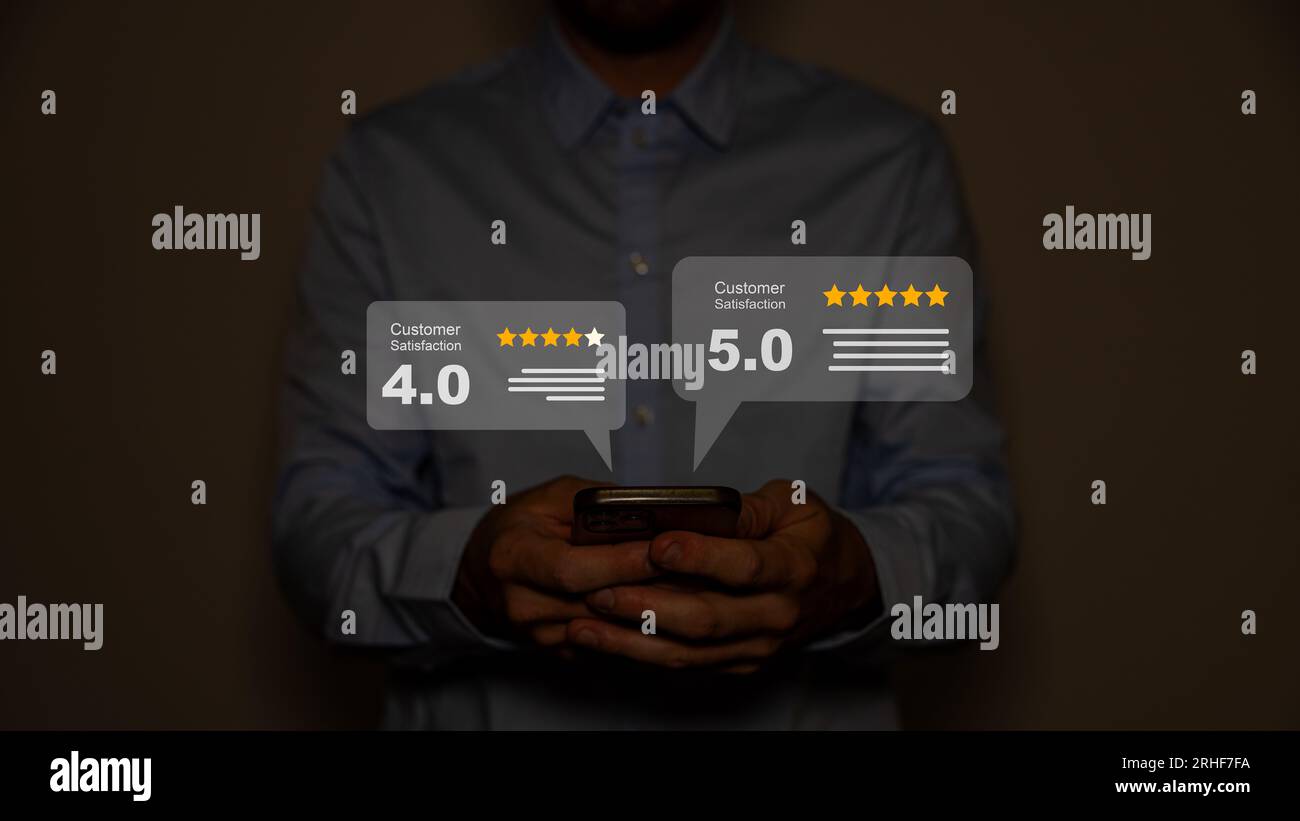 Close up on customer man hand pressing on smartphone screen with gold five star rating feedback icon and press level excellent rank. Stock Photo