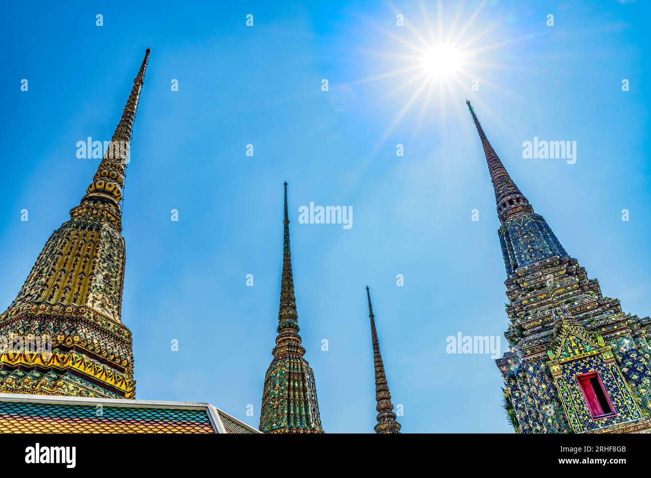 Ceramic Chedis Spires Pagodas Stretching to Sun Wat Pho Po Temple Complex Bangkok Thailand. Built in 1600s. One of oldest temples in Thailand. Stock Photo
