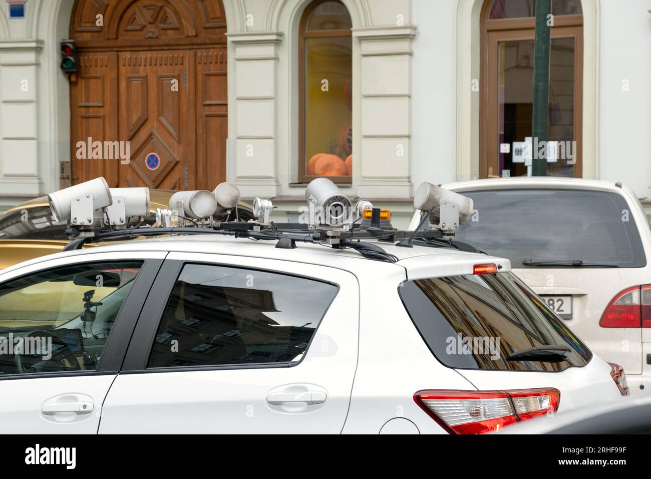 Scanning license plate for parking fee or penalty. Camera on top of car ...