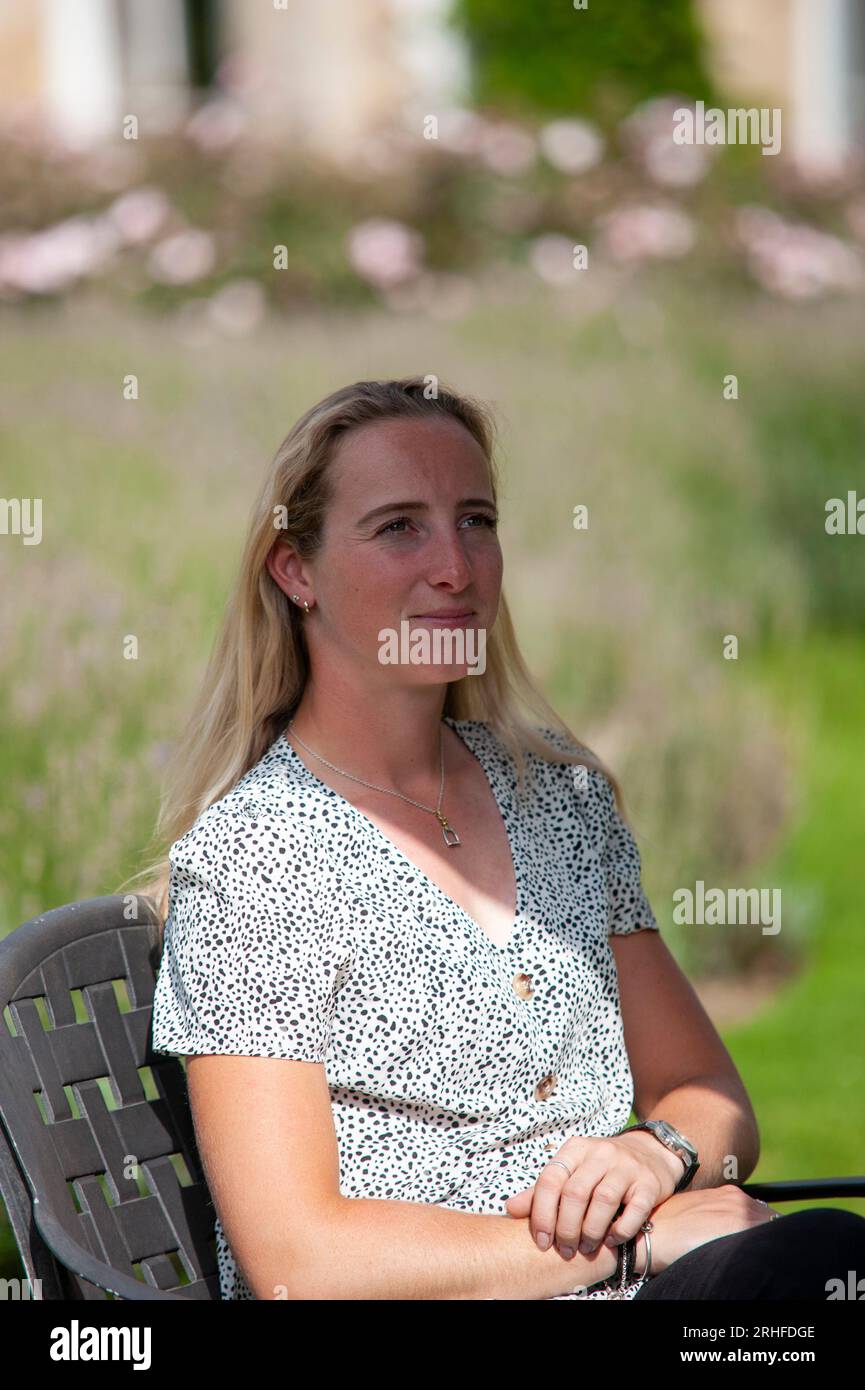 Stamford, UK. 16th Aug, 2023. Defender Burghley first-timer Greta Mason sits in the Rose Garden during the pre event media day ahead of the 2023 Defender Burghley Horse Trials held in the grounds of Burghley House in Stamford, Lincolnshire, England, United Kingdom. Credit: Jonathan Clarke/Alamy Live News Stock Photo