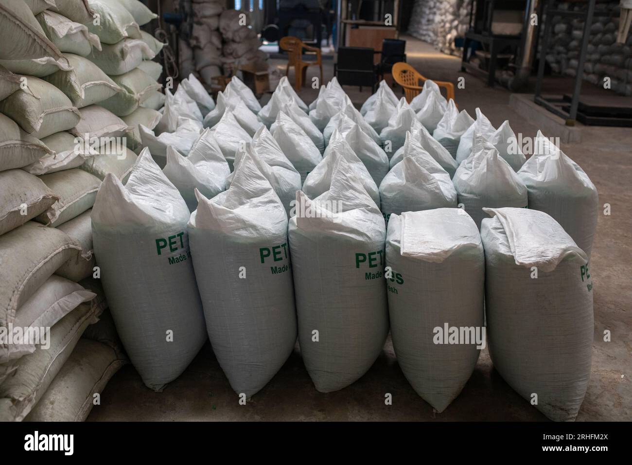 Sacks of plastic flakes made by used plastic bottles at a recycling plant in Dhaka, Bangladesh. Stock Photo