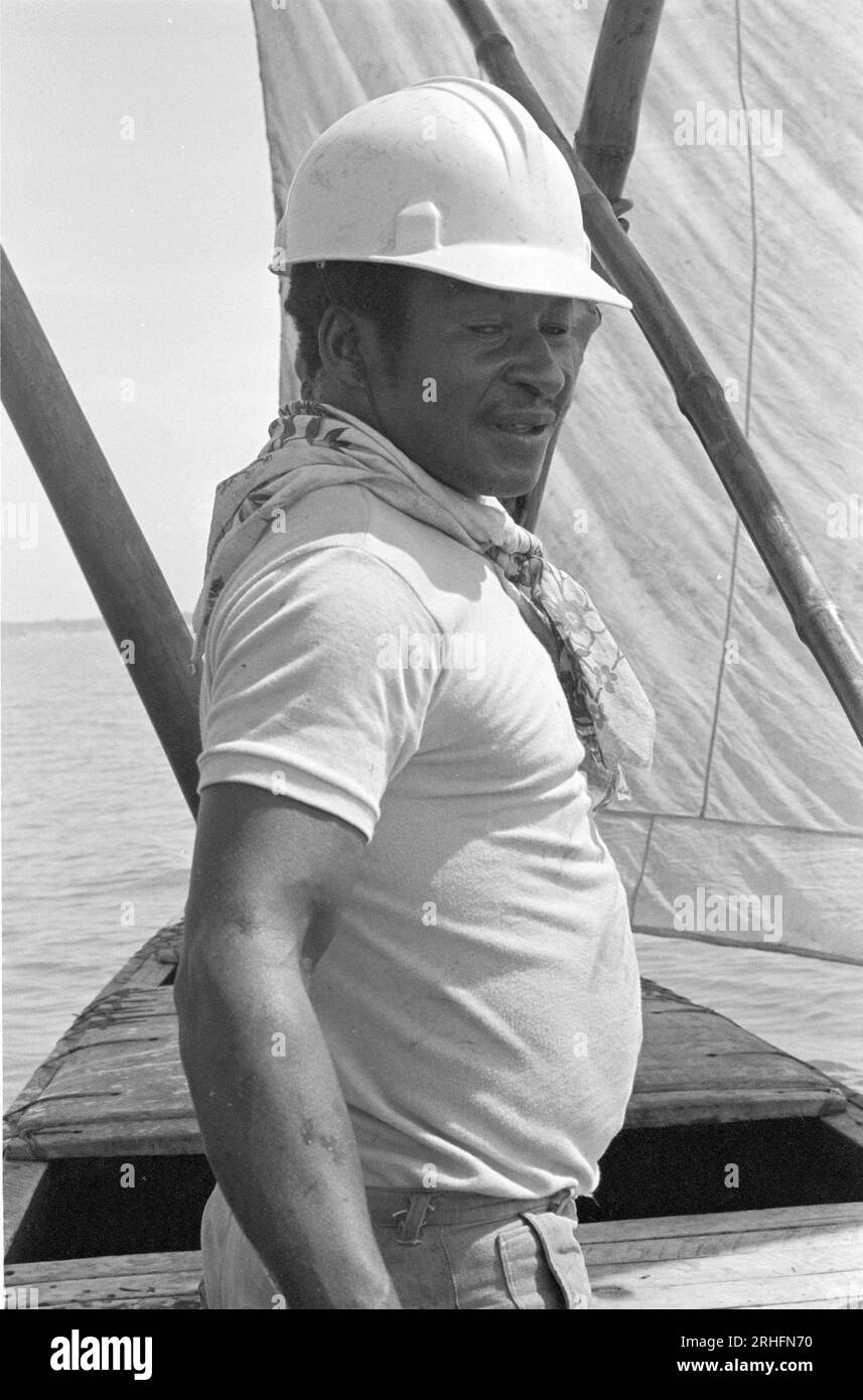Alfred Nartey, in charge of his sea-going dugout canoe. A Ga fisherman from Winneba, Ghana, he is returning to shore by sail on the prevailing wind. Stock Photo