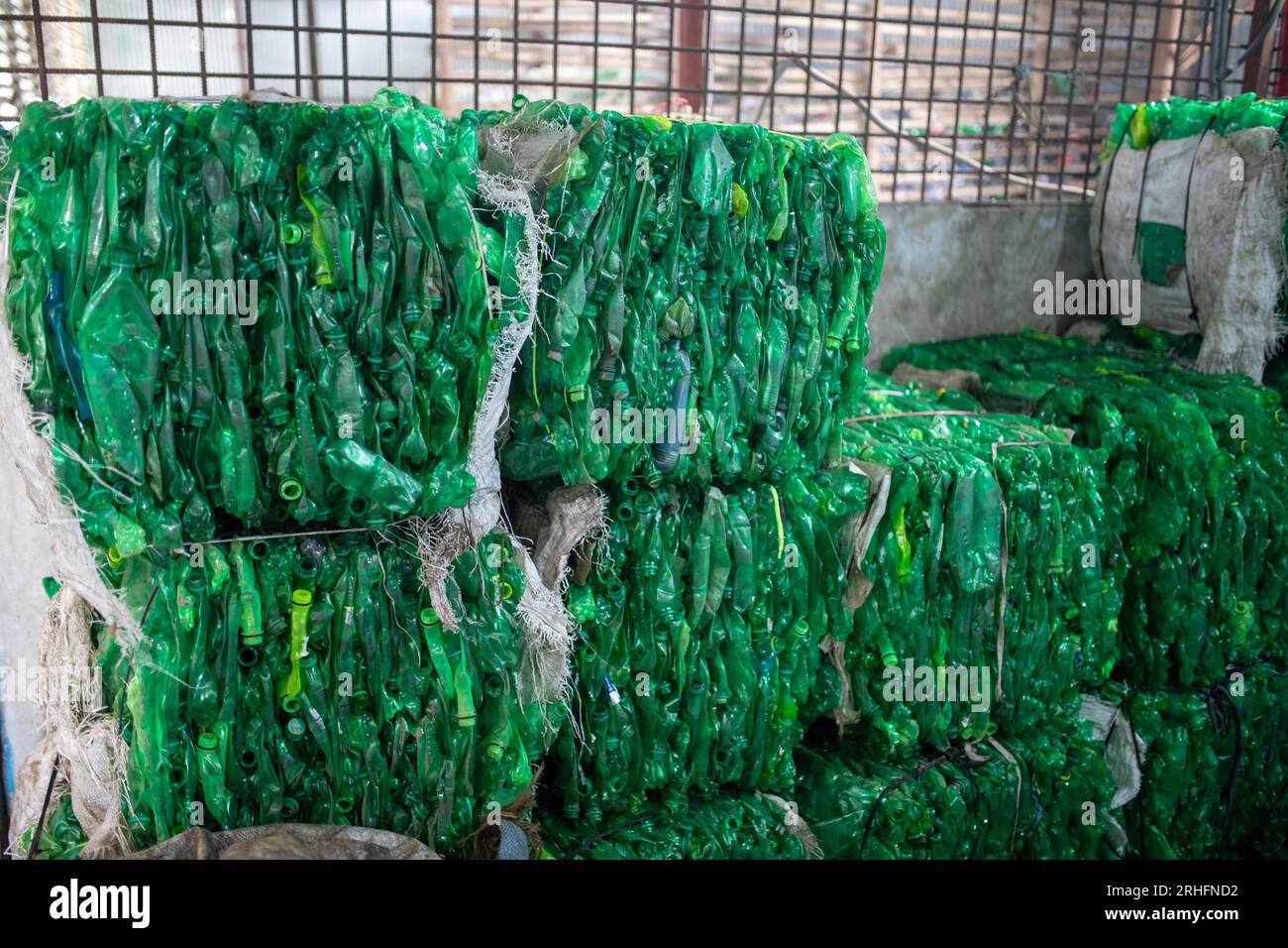 Compacted recyclable plastic bottles at a recycling plant in Dhaka