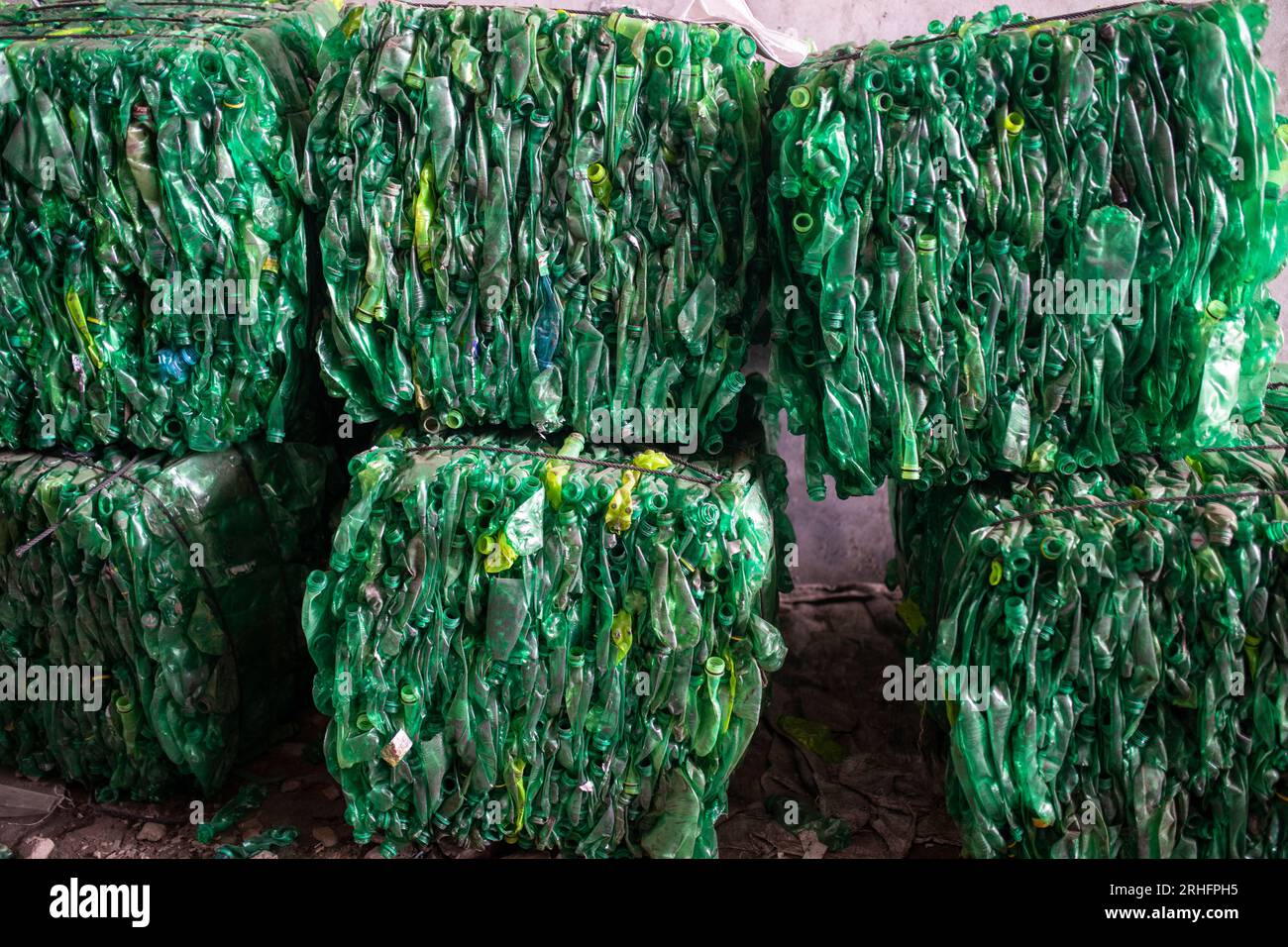 Compacted recyclable plastic bottles at a recycling plant in Dhaka