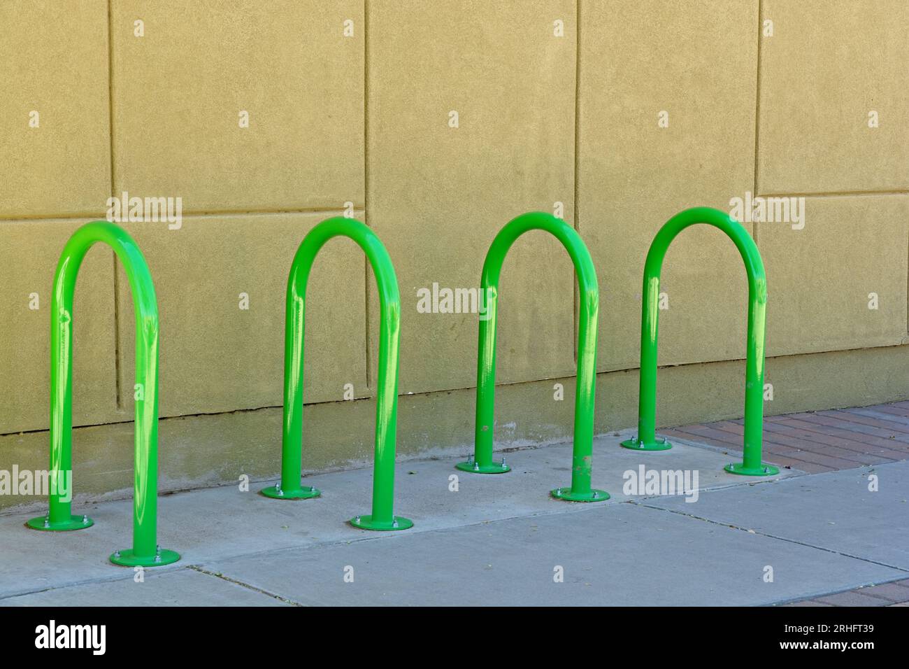 Set of brightly colored green inverted tubular U hoop bicycle rack on ...