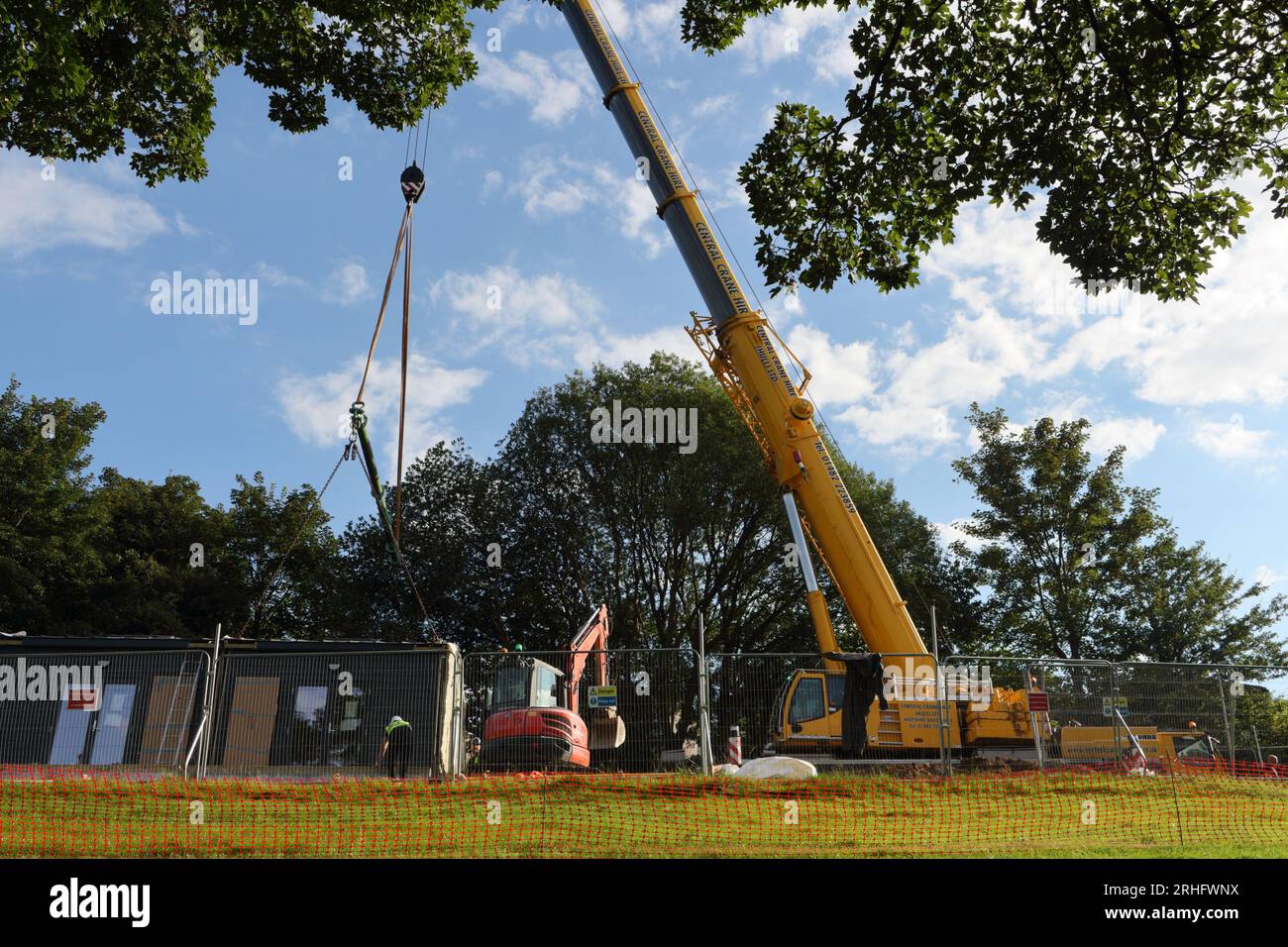 Building crane lifting prefabricated house modules under construction