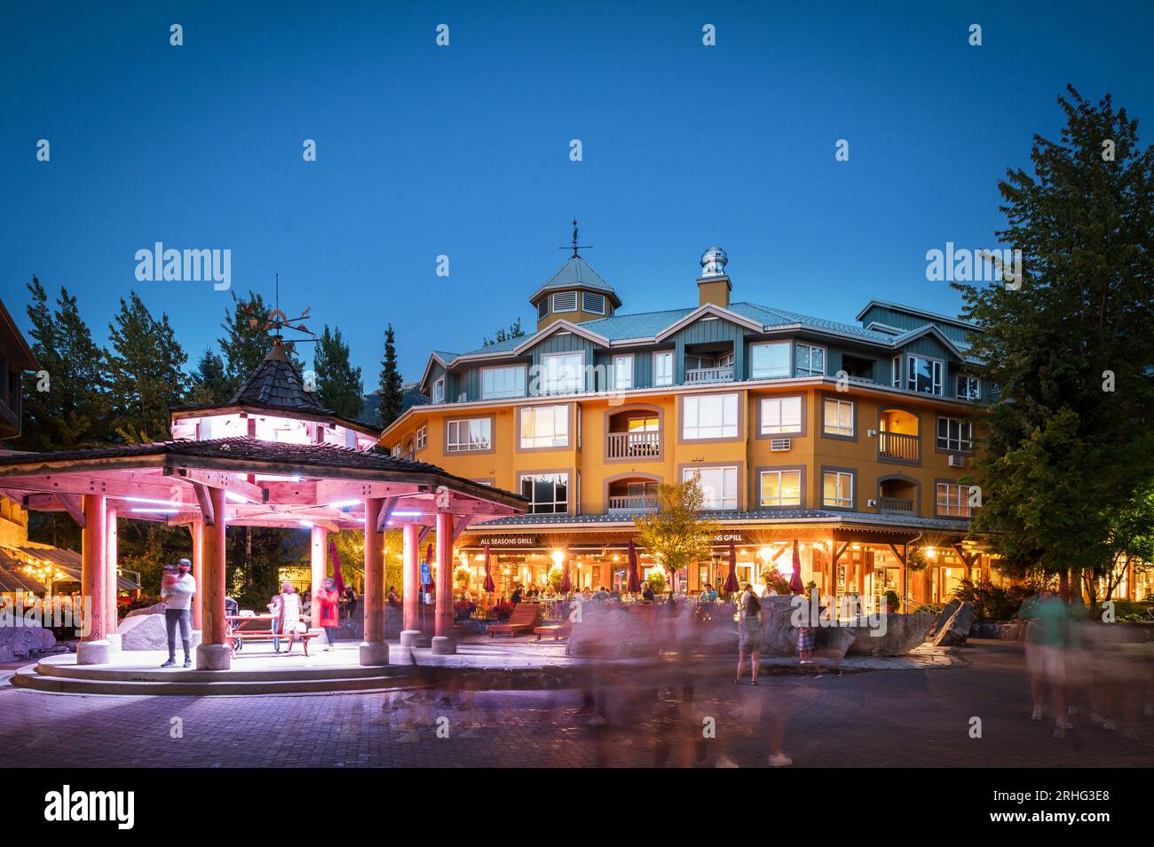 Tourists dine outside on a summer evening on restaurant patios in the Whistler Village.  Whistler BC, Canada. Stock Photo