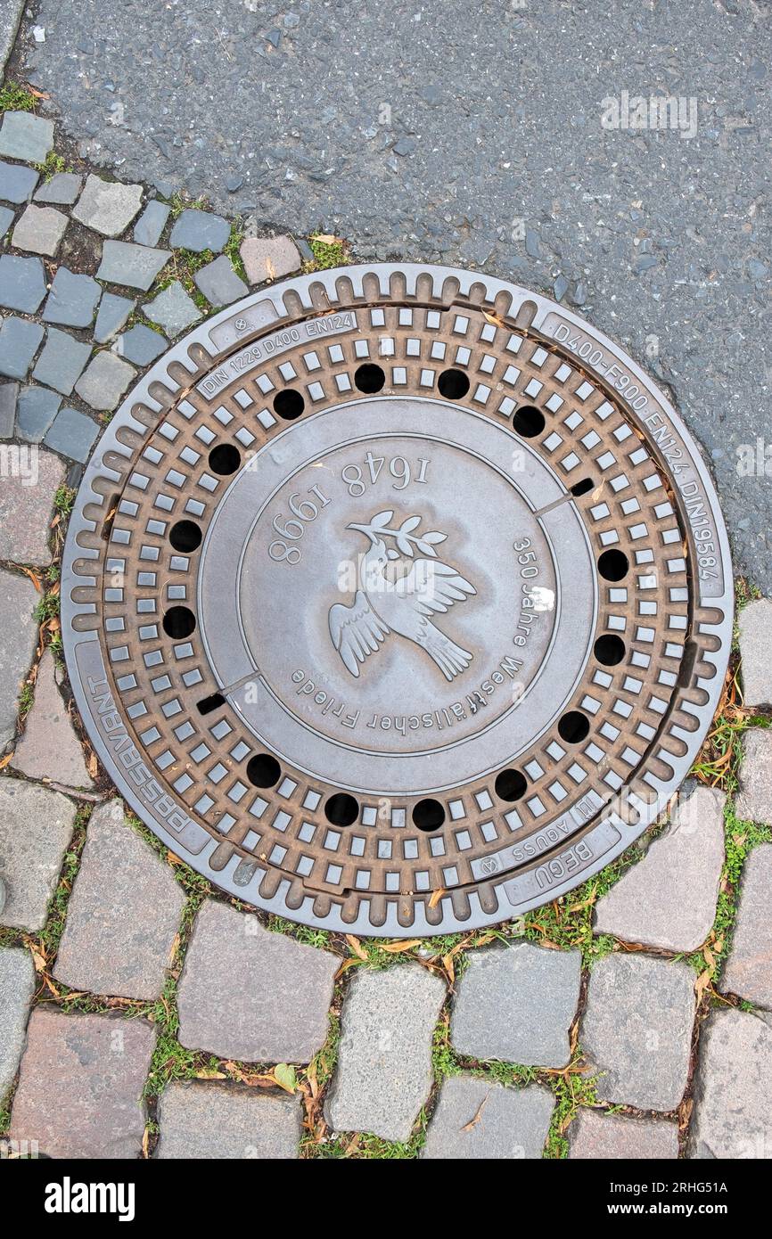 Muenster, Germany - August 5, 2023: water drain with inscription Westphalian peace - german :westpfälischer frieden to honor the historic peace agreem Stock Photo