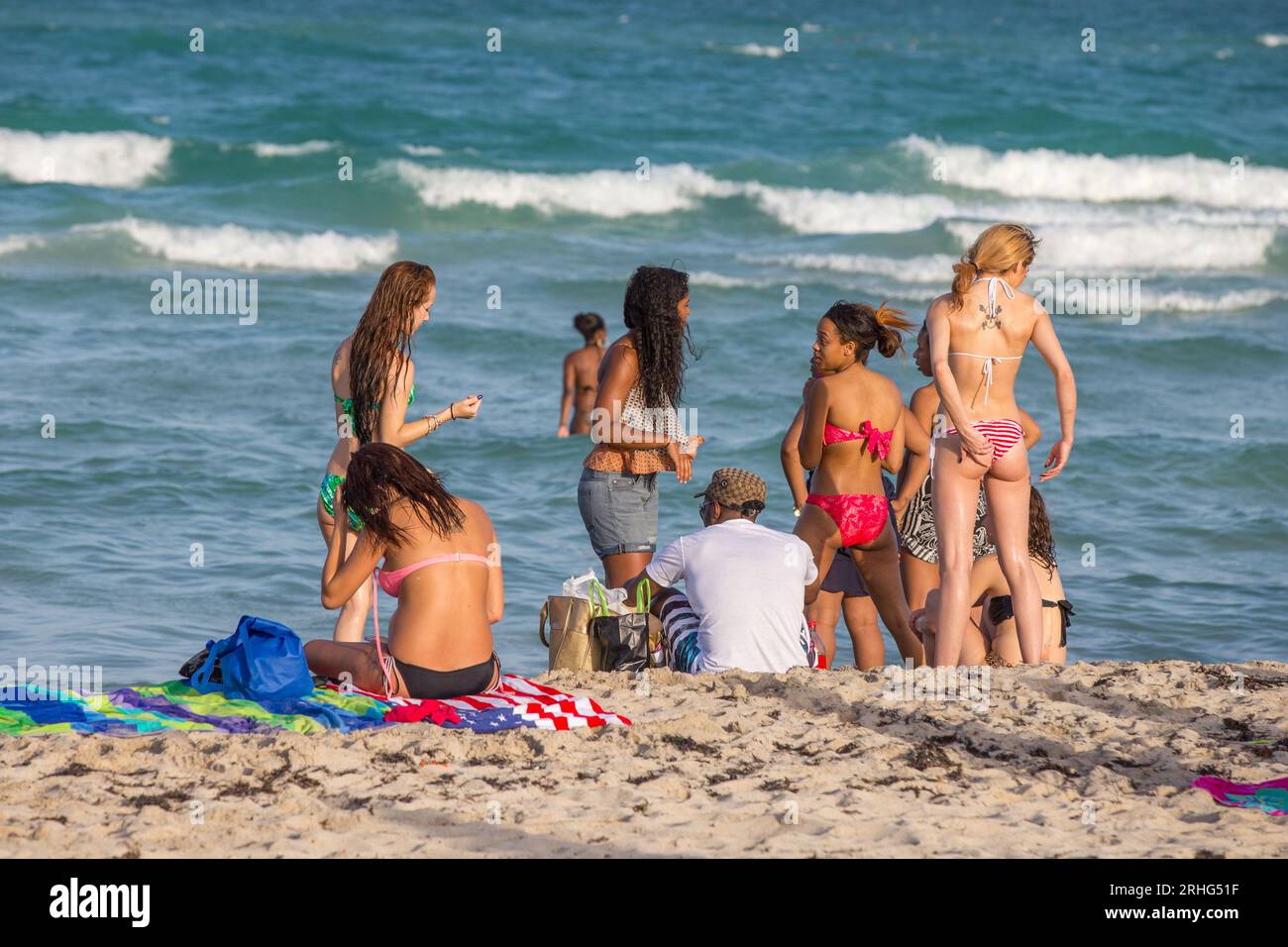 Miami, USA - August 30, 2014: people enjoy the famous south beach in Miami  Beach and relax in afternoon sun Stock Photo - Alamy, image size:1300x956