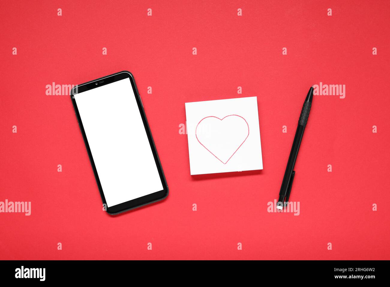 Long-distance relationship concept. Smartphone, love note and pen on ...