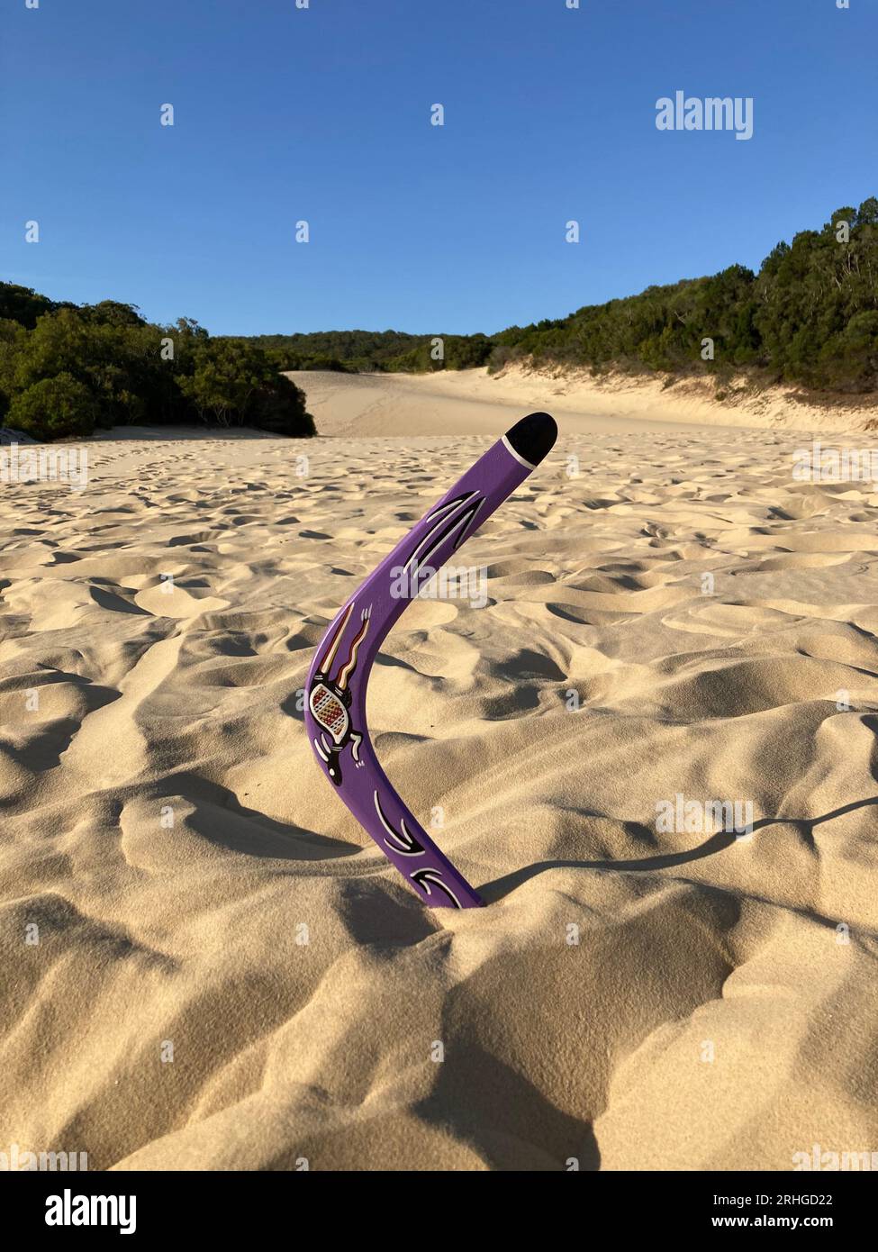 a typical australian aboriginal boomerang in the sand dunes of  fraser island / kgari, queensland, australia Stock Photo