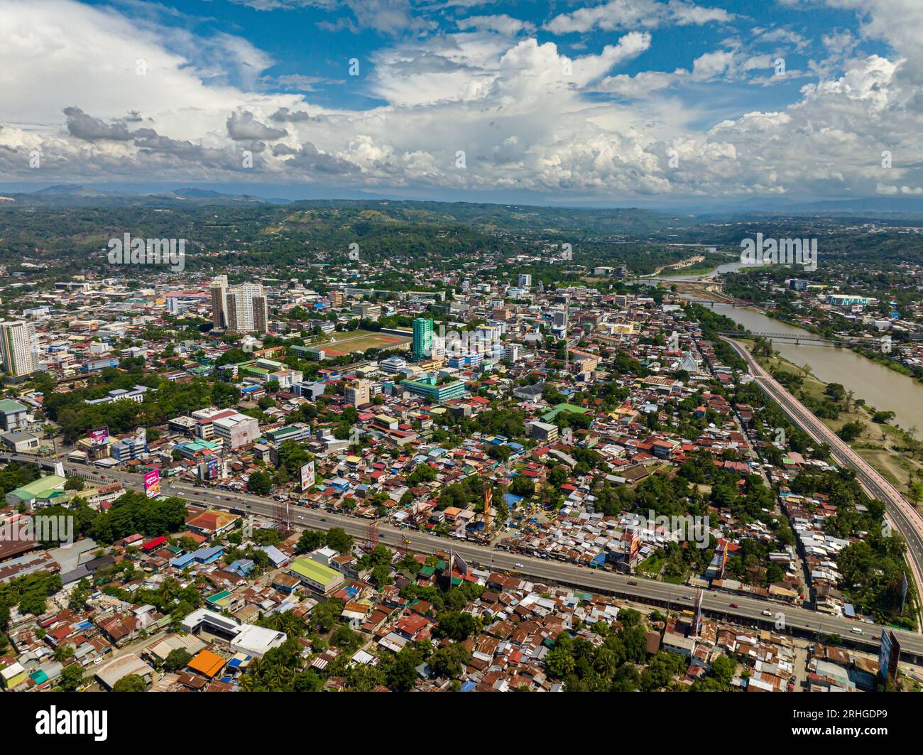 Residential area in Cagayan de Oro City, buildings ar riverside. Blue sky and clouds. Mindanao, Philippines. Stock Photo