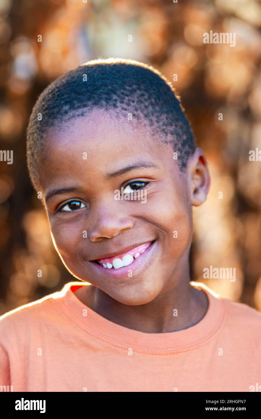 village african child with a happy expression, toothy smile on the face of the boy Stock Photo