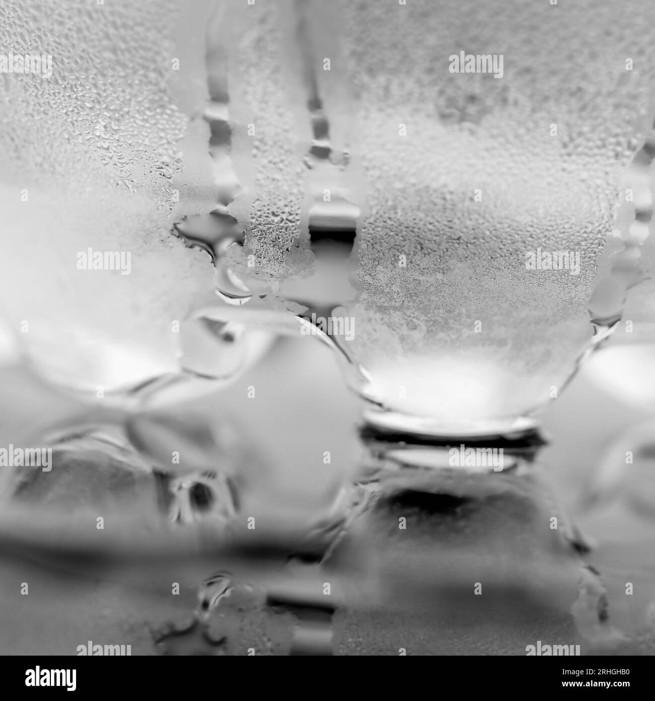 Glass of water on table, misted glass cold drink pure water dripping