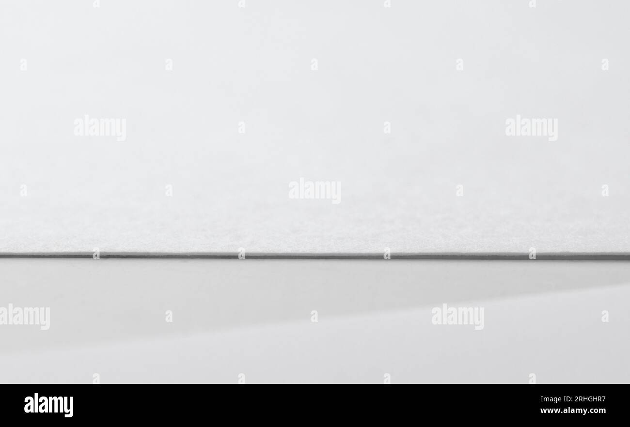 Blank paper sheet on white table with shadow Stock Photo