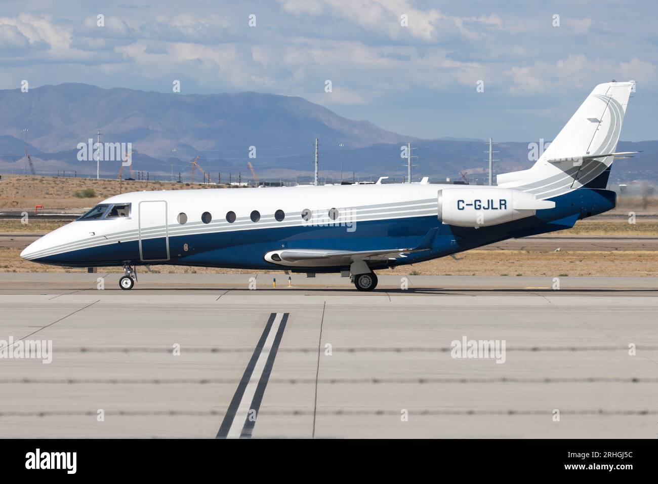 A twin engine Gulfstream G200 business jet (C-GJLR) taxiing at the Mesa Gateway Airport after landing from Toronto, Canada. Stock Photo